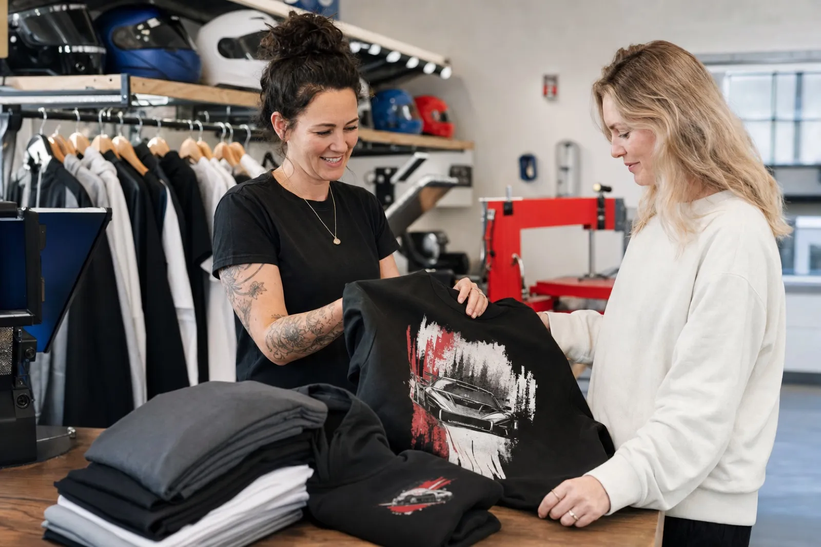 New Zealand apparel team reviewing a motorsport-inspired custom printed T-shirt