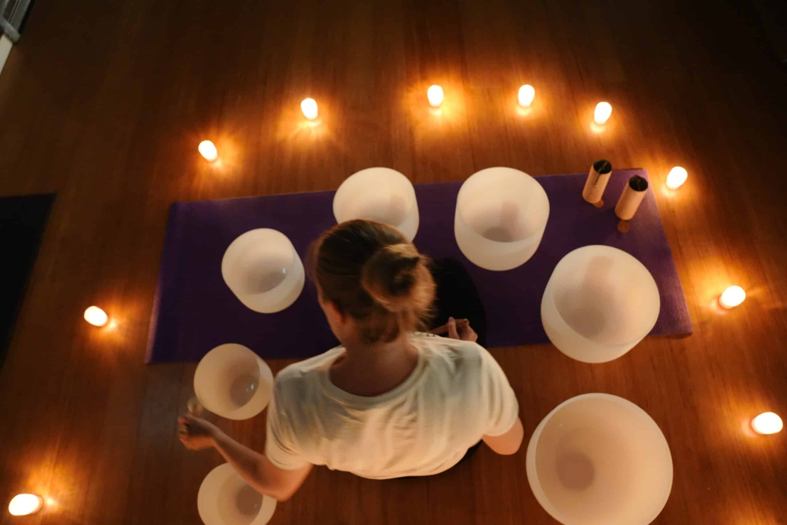 Holly Neighbours preparing crystal singing bowls for an Auckland sound healing session