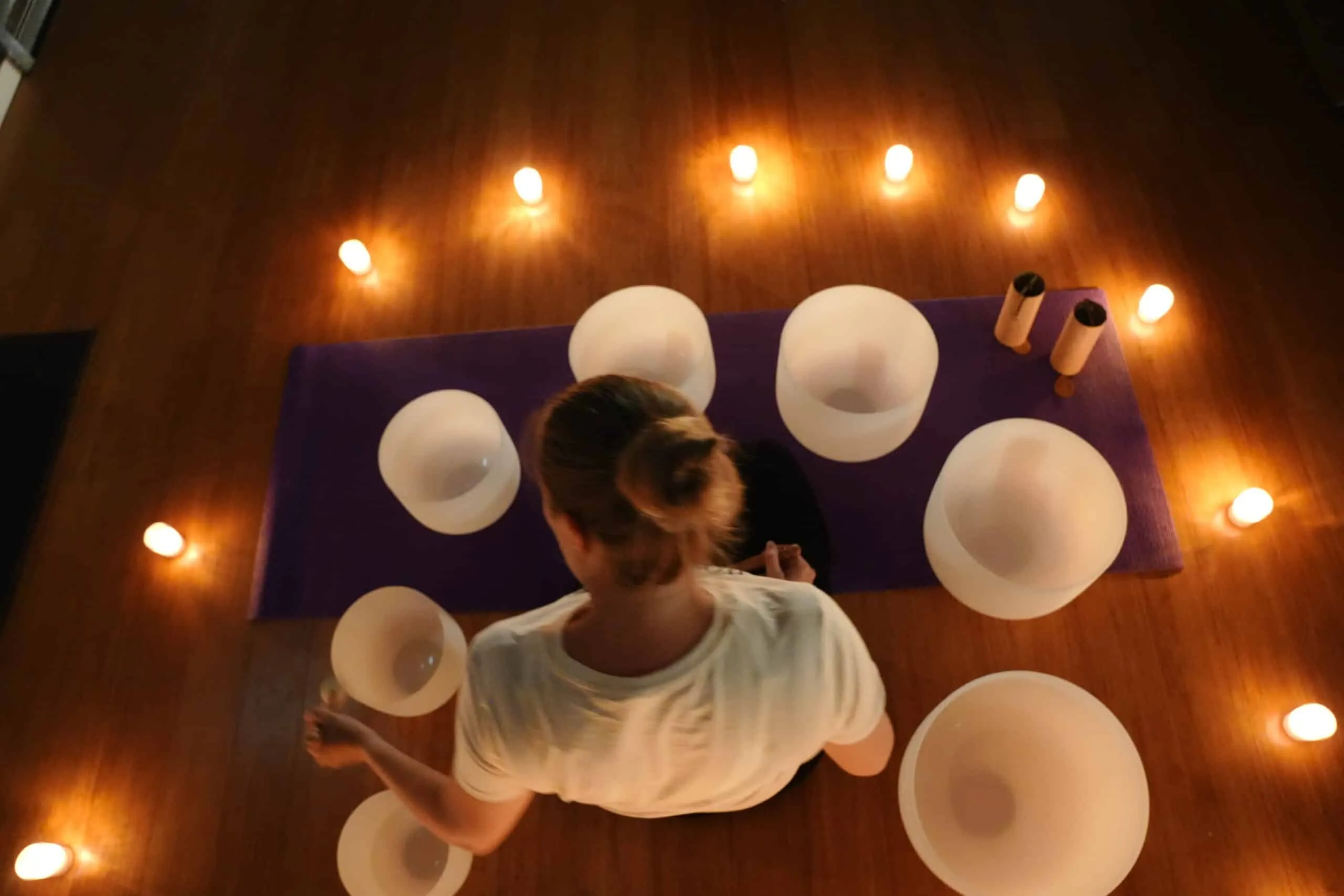 Holly Neighbours preparing crystal singing bowls for an Auckland sound healing session