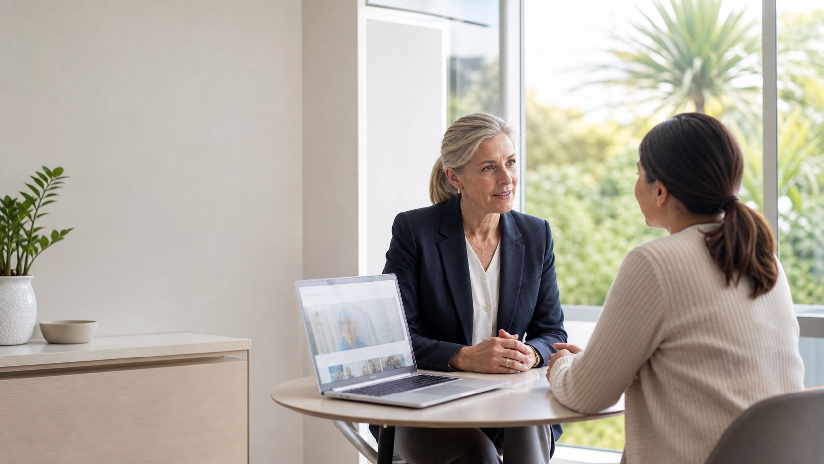 New Zealand surgeon discussing specialist care with an adult patient in a modern Auckland clinic