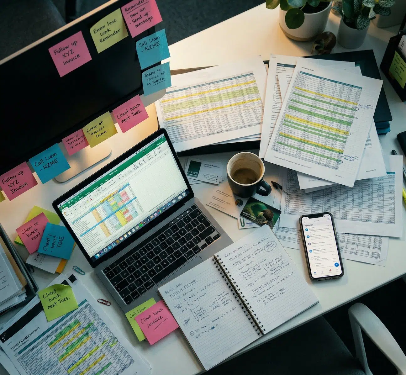 Before: messy desk with spreadsheets and sticky notes