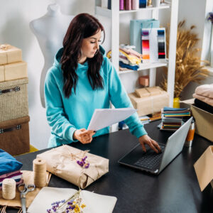How to pick a CRM – business owner researching CRM options on laptop
